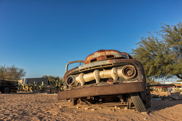 Old and abandoned car in the desert of Namibia. Solitaire. With the beautiful light of the sunrise.