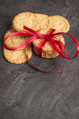 baked wafer on a black table. cookies tied in a red bow