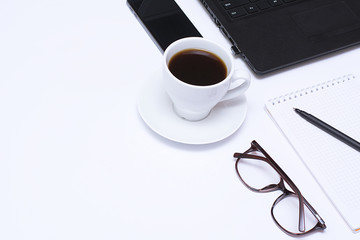Mixing stationery and gadgets on a white background. View from above.
