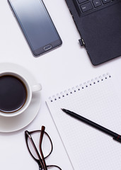 Mixing stationery and gadgets on a white background. View from above.