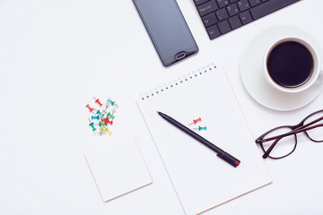 Mixing stationery and gadgets on a white background. View from above.