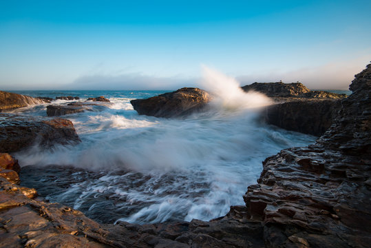 Heavy waves break on a hidden beach near Davenport California