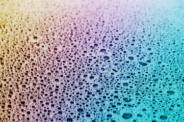 Close up of water drops at a glass table 