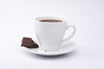Hot chocolate and chocolate pieces isolated on white background