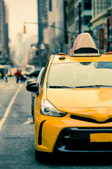 New York City street scene with yellow taxi cab on urban street