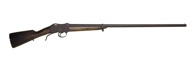 old hunting shotgun with a darkened cracked butt, remade from an army rifle, isolated