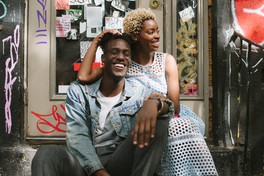 Cute Couple Sitting On Stoop In City