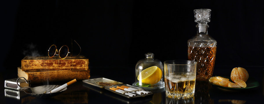 Panorama still life with whiskey and antique objects in retro style