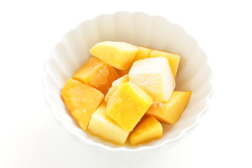 Fototapeta na wymiar Frozen mango on white bowl for gourmet dessert image