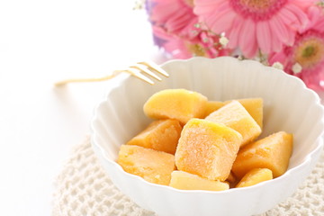Frozen mango on white bowl for gourmet dessert image