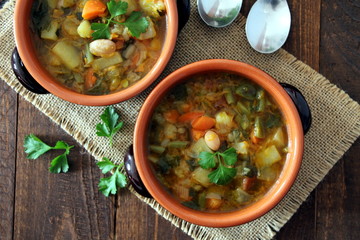 Vegetables soup on the wooden background. Vegetarian and vegan food. Top view.