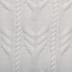 Knitted background. Knitted white texture. A knitting pattern of wool. Knitting. Background.