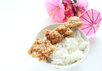 fried chicken and bamboo skewer on rice