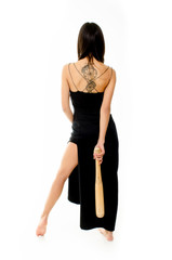 Sexy young girl with tattoo in black dress and baseball bat, isolated on white background