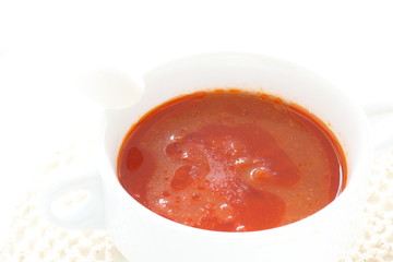 Tomato soup in white bowl