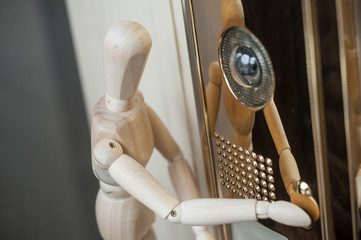 closeup of wooden puppet and inerphone with camera - concept security