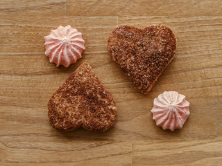 meringue, cinnamon hearts cookies wood texture table