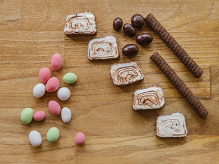 colored nuts and turkish delight and chocolate stick wood texture