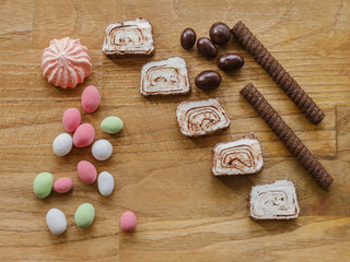 colored nuts and turkish delight and chocolate stick wood texture