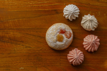 cookie and meringues on wooden table