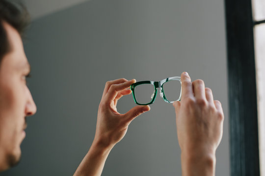 Close up of hands checking the polishing of a glasses frame
