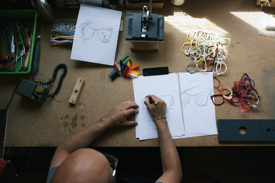 Artisan eyewear designer drawing some glasses designs