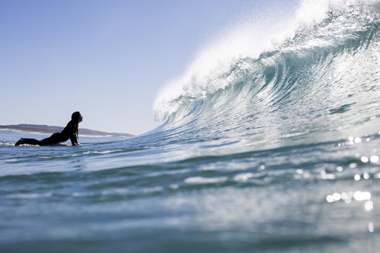 Surfer about to duck dive breaking wave