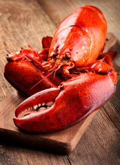 Red lobste on cutting board on wooden background