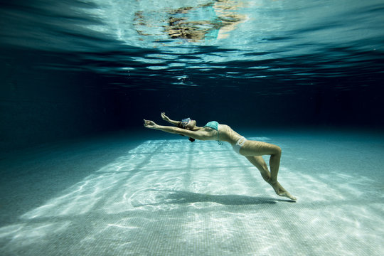 Underwater woman with bikini in swimming pool