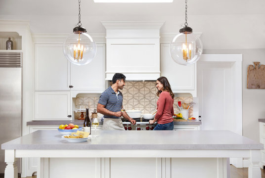 Young couple cooking together at home
