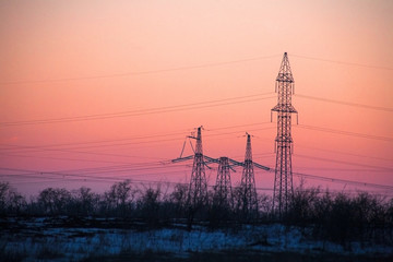 Electricity Pylon - power lines overhead power line transmission tower of the sunset.