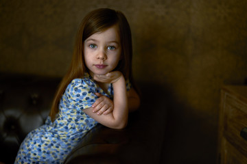 Portrait of little girl on dark background