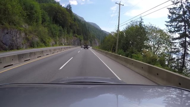 POV mounted shot on car cruising on the Sea to Sky Highway during summer