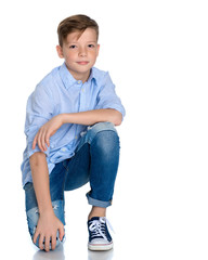 Fototapeta premium Fashionable boy teen sitting on the floor.