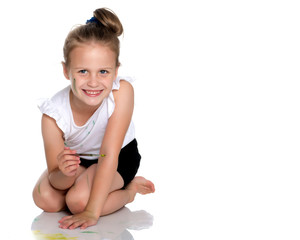 A little girl draws paints on her body