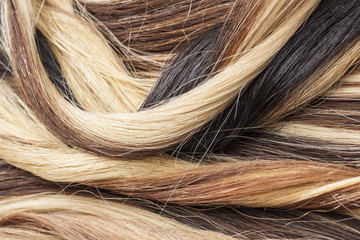 Real hair closeup. Hair texture pattern macro photo. Human european women's hair extension.