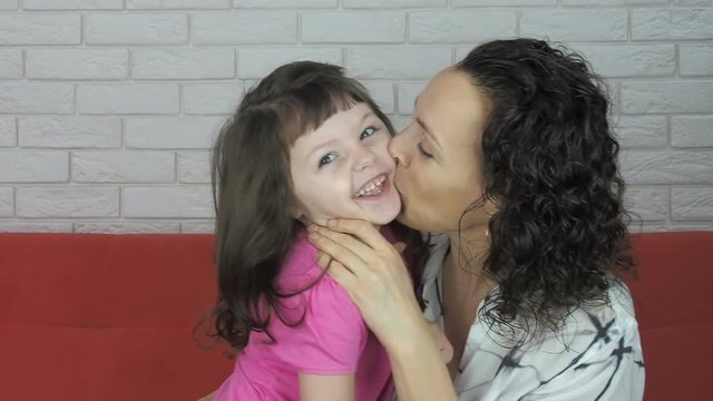 Mom tickles the child. Mom plays with her daughter.