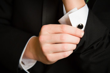 Fototapeta premium Teenager Adjusts Cufflinks for Prom