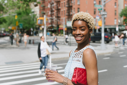 Young happy woman with bubble tea in city