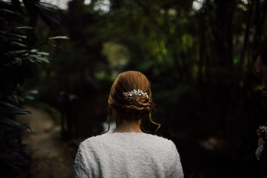 Backside view of the bride in nature