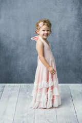 Happy Preschool Girl with Curly Hair Wearing Twirly Pink Dress