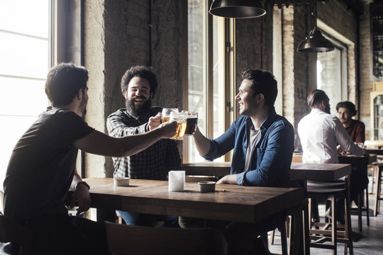 Friends Drinking Beer at Pub