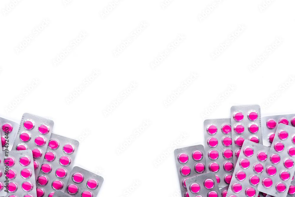 Sticker round pink tablets pills in blister packs on white background with copy space. tablets pills for rel