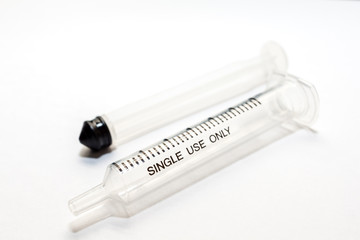 A plastic medical syringe, with out injection needle on white background.