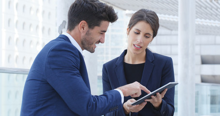 Business people discuss on tablet computer