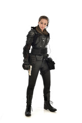 full length portrait of female  soldier wearing black  tactical armour, holding a remote knife, isolated on white studio background.