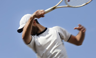 male tennis player in action, motion blurs