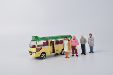 Miniature travellers at a busy bus station