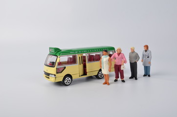 Miniature travellers at a busy bus station