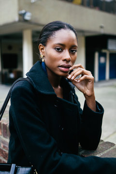 Beautiful African woman standing in front of an apartment block